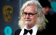 Scottish comedian and actor Billy Connolly poses on the red carpet upon arrival to attend the annual BAFTA British Academy Film Awards at the Royal Opera House in London on 10 February 2013. Picture: Andrew Cowie/AFP