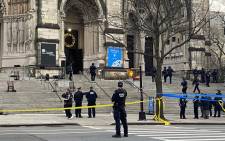 Police are seen outside of the Cathedral of St. John the Divine in New York on December 13, 2020, after a shooter opened fire outside the church before police returned fire and took the man into custody. Picture: AFP.