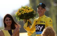 Tour de France 2016 winner Christopher Froome celebrates his overall leader yellow jersey on the podium on the Champs-Elysees avenue in Paris, at the end of the 113 km twenty-first and last stage of the 103rd edition of the Tour de France cycling race on 24 July, 2016 between Chantilly and Paris. Picture: AFP.