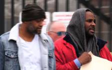 This still image from video shows singer R. Kelly (R) upon his release from Cook County jail in Chicago, Illinois, Saturday, 9 March 2019 after paying child support following a previous detention on sex abuse charges. Picture: AFP