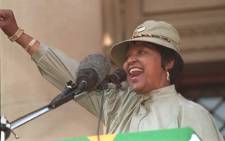 FILE: Anti-apartheid campaigner Winnie Madikizela-Mandela forms the ANC clenched fist and salutes supporters during a rally in Johannesburg on 16 June 1996 to mark the 20th anniversary of the Soweto student uprising.  Picture: AFP.