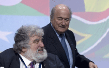 Fifa's Sepp Blatter walks behind Chuck Blazer. Picture: AFP