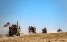 FILE: A US military convoy takes part in a joint patrol with Turkish troops in the Syrian village of al-Hashisha on the outskirts of Tal Abyad town along the border with Turkish troops, on 8 September 2019. Picture: AFP