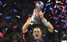 FILE: In this file photo taken on February 05, 2017, Tom Brady of the New England Patriots holds the Vince Lombardi Trophy after defeating the Atlanta Falcons 34-28 in overtime during Super Bowl 51 in Houston, Texas. Picture: Timothy A. Clary / AFP