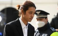 K-pop star Jung Joon-young (C) arrives for questioning at the Seoul Metropolitan Police Agency in Seoul on 14 March 2019. Picture: AFP