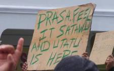 Satawu member holds up a sign during protest.