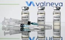 FILE: An illustration picture shows vials with COVID-19 Vaccine stickers attached and syringes with the logo of French-Austrian vaccine firm Valneva on 17 November 2020. Picture: JUSTIN TALLIS/AFP
