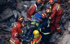 Members of a rescue team carry out a survivor of a building collapse in Shanghai on 16 May 2019. Picture: AFP
