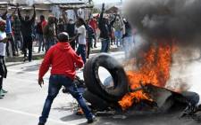 Alexandra township residents burn tyres in the middle of the street as they clash with the Johannesburg Metro Police on 3 April 2019 in Johannesburg, South Africa. Picture: AFP