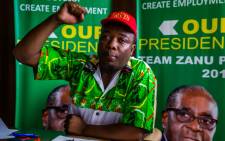 Zanu-PF Youth leader Kudzai Chipanga raises his fist as he chants the ruling party's slogan at a media conference on 14 November 2017 in Harare. Picture: AFP.