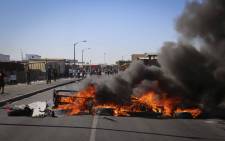 FILE: Burning tyres block a road during a protest by disgruntled Vrygrond residents. Picture: Cindy Archillies/EWN.