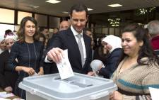 A handout picture released by the official Syrian Arab News Agency on 13 April, 2016 shows Syrian President Bashar al-Assad and his wife Asma (left) casting their votes at a polling station in Damascus during the parliamentary elections. Picture: AFP.