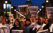 Parents and victims of priest abuse from around the world hold banners during a demonstration in Rome in front of the Vatican dome on October 31, 2010. Picture: