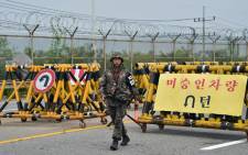 A South Korean soldier walks by barricades on the road leading to North Korea’s Kaesong joint industrial complex at a military checkpoint in the border city of Paju on 21 August, 2015. Picture: AFP.