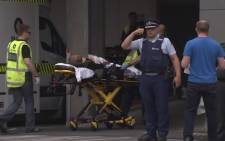 An image grab from TV New Zealand taken on 15 March 2019 shows a victim arriving at a hospital following the mosque shooting in Christchurch. Picture: AFP.