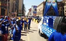 Democratic Alliance members chant outside the High Court in Pretoria as they wait for the so-called Zuma spy tapes to be handed to the party on 4 September, 2014. Picture: Picture: Vumani Mkhize/EWN.