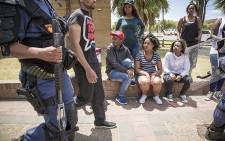 Students watch as police arrest a protesting student at the Cape Peninsula University of Technology Bellville Campus. Picture: Thomas Holder/EWN