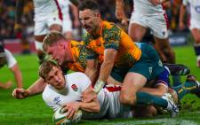 England's Jack Nowell (L) is tackled by Australia's Matt Philip (C) and Nic White (R) during the International rugby union match between England and Australia at Suncorp Stadium in Brisbane on 9 July 2022. Picture: Patrick HAMILTON/AFP