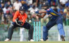 Sri Lankan cricketer Sadeera Samarawickrama (R) is watched by England wicketkeeper Jos Buttler (L) as he plays a shot during the fifth and final one day international (ODI) cricket match between Sri Lanka and England at the R. Peremadasa Stadium in Colombo on 23 October 2018.  Picture: AFP