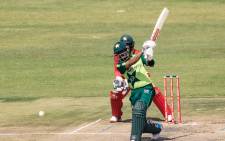 Pakistan's Babar Azam plays a shot as wicket keeper Regis Chakabva looks on during the third Twenty20 international cricket match between Zimbabwe and Pakistan at the Harare Sports Club in Harare on April 25, 2021. Picture: Jekesai Njikizana / AFP