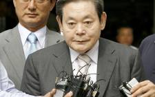 FILE: In this file photo taken on July 11, 2008 Lee Kun-Hee (C), former Samsung Group chairman, leaves after his trial as reporters ask him questions at a Seoul court. Picture: AFP