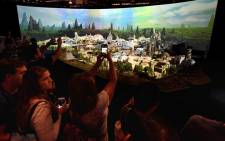 'Star Wars' fans view plans at the California and Florida Disneylands for the new development that will open in 2019 during the D23 expo fan convention at the Convention Center in Anaheim, California, on 16 July 2017. Picture: AFP.