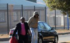 Donald Sebolai, known as DJ Donald Duck, arrives under police guard at the Protea Magistrate’s Court in Soweto on 10 July 2014 ahead of his appearance in connection with the murder of his girlfriend. Picture: Sapa.