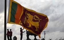 FILE: Military personnel in ceremonial uniform lower the Sri Lanka national flag at Galle Face Green in Colombo on July 23, 2022. Picture: Arun SANKAR / AFP