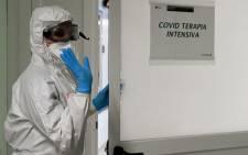 FILE: A member of the medical staff wearing personal protective equipment (PPE) arrives in the Intensive Care Unit (ICU) for the COVID-19 cases, in the San Filippo Neri Hospital in Rome, on 29 October 2020. Picture: AFP