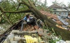 A man salvages items from his house damaged by cyclone Amphan in Midnapore, West Bengal, on 21 May 2020. Picture: AFP