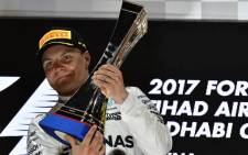 Mercedes' Finnish driver Valtteri Bottas celebrates on the podium at the end of the Abu Dhabi Formula One Grand Prix at the Yas Marina circuit on 26 November, 2017. Picture: AFP