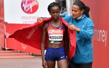 FILE: Kenya's Brigid Kosgei is wrapped in a towel after winning the elite women's race of the 2019 London Marathon in central London on April 28, 2019. Picture: AFP