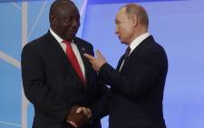 FILE: Russian President Vladimir Putin greets President Cyril Ramaphosa during the official welcoming ceremony for the heads of state and government of states participating in the 2019 Russia-Africa Summit in Sochi on 23 October 2019. Picture: AFP.
