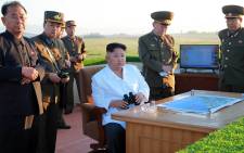 This undated picture released by North Korea's official Korean Central News Agency (KCNA) on 28 May, 2017, shows North Korean leader Kim Jong-Un (C) inspecting the test of a new anti-aircraft guided weapon system organised by the Academy of National Defence Science at an undisclosed location. Picture: AFP.
