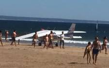 A small aeroplane is seen at Sao Joao de Caparica beach. Picture: Twitter/@omalestafeito.