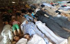 A handout image released by the Syrian opposition's Shaam News Network shows people inspecting bodies of children and adults laying on the ground as Syrian rebels claim they were killed in a toxic gas attack by pro-government forces in eastern Ghouta, on the outskirts of Damascus on August 21, 2013. Picture: AFP