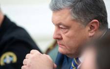 FILE: This handout picture taken and released by the Ukrainian Presidential press service shows President of Ukraine Petro Poroshenko leading a session of the National Security and Defense Council of Ukraine in Kiev early on 26 November 2018, following an incident in the Black Sea off Moscow-annexed Crimea. Picture: AFP