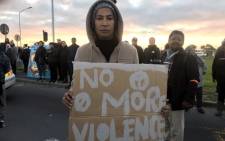 FILE: A Bonteheuwel resident stands with a placard during a protest against gang violence on 29 August 2018. Picture: Shamiela Fisher/EWN