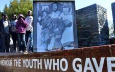 FILE: 12 year-old Hector Pieterson (seen on the picture at L) was shot on 16 June, 1976 during the Soweto uprising that today is a symbol of resistance to the brutality of the apartheid government. Picture: AFP. 