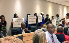Black First Land First members disturb meeting by raising banners supporting Public Protector Busisiwe Mkhwebane. Picture: Babalo Ndenze/EWN.