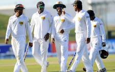 Sri Lanka cricket captain Angelo Mathews (2L) and teammates leave the pitch at the close of play on the final day of the first cricket Test match between Pakistan and Sri Lanka at the Sheikh Zayed Stadium in Abu Dhabi on January 4, 2014. The first Pakistan - Sri Lanka Test ended in draw. Picture: AFP.