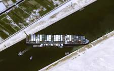 This handout satellite image courtesy of Cnes 2021 released on March 25, 2021 by Airbus DS shows the Taiwan-owned MV 'Ever Given' (Evergreen) container ship, a 400-metre- (1,300-foot-)long and 59-metre wide vessel, lodged sideways and impeding all traffic across the waterway of Egypt's Suez Canal. Picture: Distribution Airbus DS / AFP.