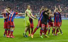 Bayern Munich’s players celebrate after the UEFA Champions League second-leg quarter-final football match Bayern Munich v FC Porto in Munich, southern Germany on 21 April, 2015. Picture: AFP.