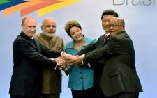 Russian President Vladimir Putin, India's PM Narendra Modi, Brazilian President Dilma Rousseff, China's President Xi Jinping and South Africa's Jacob Zuma gesture during the 6th BRICS Summit in Fortaleza, Brazil, on 15 July 2014. Picture: AFP. 