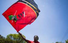 FILE: An Economic Freedom Fighters (EFF) member waves the party's flag outside the Israel Embassy in Pretoria during a free Palestine protest. Picture: Thomas Holder/EWN.