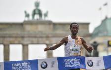 FILE: Ethiopia's Kenenisa Bekele crosses the finish line to win the Berlin Marathon on 29 September 2019 in Berlin. Picture: AFP