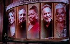 (L-R) The 2023 honorees Renee Fleming, Barry Gibb, Queen Latifah, Billy Crystal and Dionne Warwick are pictured on screen as host Cuban singer-songwriter Gloria Estefan opens the show during the 46th Kennedy Center Honors at the Kennedy Center on 3 December 2023, in Washington, DC. Picture: Kent Nishimura / AFP