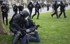 Riot police forces arrest a young man following clashes between demonstrators and riot-police during a protest of students against police brutality, following the alleged rape of Theo in Paris, on February 23, 2017. Picture: AFP.