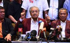 Malaysian prime minister Mahathir Mohamad celebrates with other leaders of his coalition during a press conference in Kuala Lumpur on 10 May 2018. Picture: AFP.