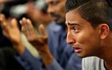 A youth cries during congregational Friday prayers at the Jamia Masjid mosque in Hamilton on 22 March  2019, one week after the Christchurch twin mosque massacre. Picture: AFP